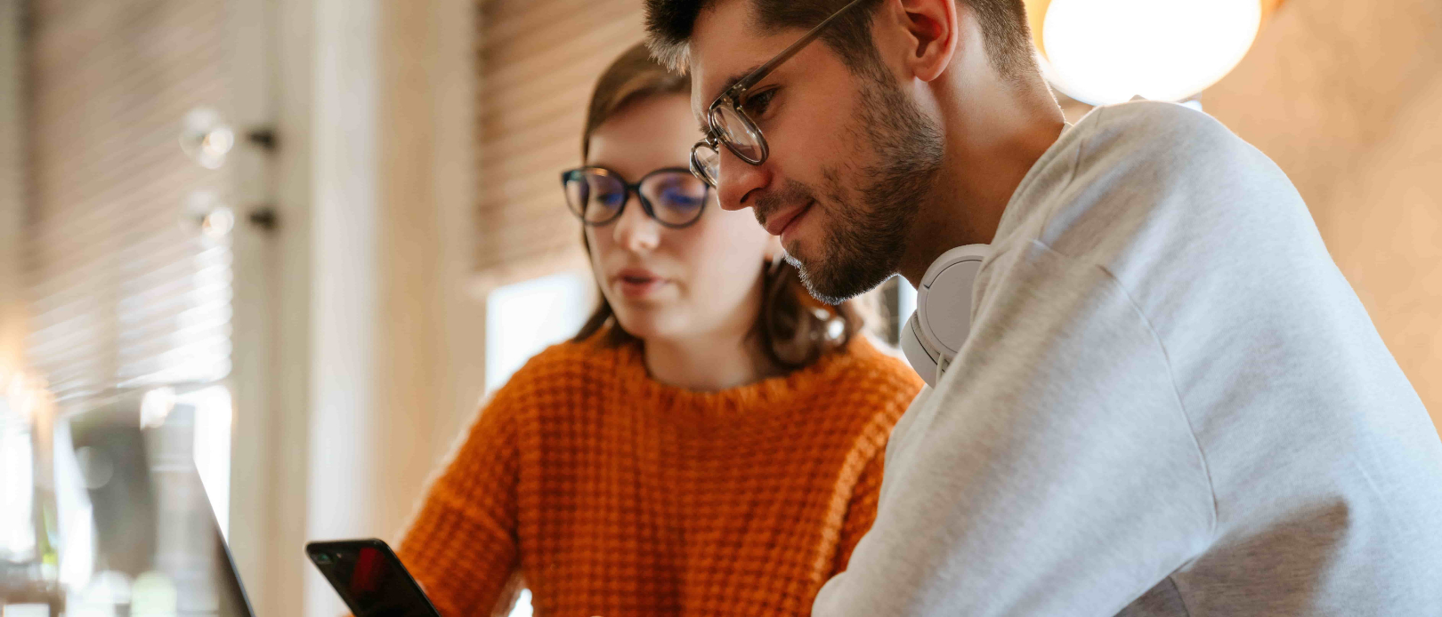 White young colleagues using gadgets while working together in office indoors